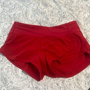 lululemon shorts in very good condition !! color is red and 2.5 inch speed ups!!